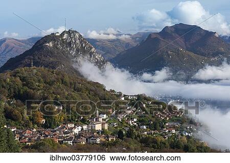 "Excursion mountain of San Salvatore with the village of Cisano at the front, autumn morning with patches of fog over Lake Lugano, Monte Bre at the rear, Lugano, Canton of Ticino, Switzerland, Europe" View Large Photo Image Stock Photograph - "Excursion mountain of San Salvatore with the village of Cisano at the front, autumn morning with patches of fog over Lake Lugano, Monte Bre at the rear, Lugano, Canton of Ticino, Switzerland, Europe". Fotosearch