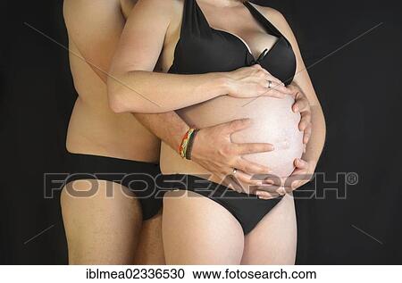 "Expectant parents, man hugging a pregnant young woman, 9 months" View Large Photo Image Stock Image - "Expectant parents, man hugging a pregnant young woman, 9 months". Fotosearch