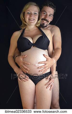 "Expectant parents, man hugging a pregnant young woman, 9 months" View Large Photo Image Stock Image - "Expectant parents, man hugging a pregnant young woman, 9 months". Fotosearch