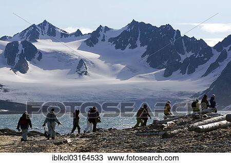"Expedition participants hiking near Smeerenburg in front of the mountain and glacier scenery of Vasahalvoya, Smeerenburgfjorden, Amsterdamoya, Svalbard Archipelago, Svalbard and Jan Mayen, Norway, Europe" View Large Photo Image Stock Image - "Expedition participants hiking near Smeerenburg in front of the mountain and glacier scenery of Vasahalvoya, Smeerenburgfjorden, Amsterdamoya, Svalbard Archipelago, Svalbard and Jan Mayen, Norway, Europe". Fotosearch