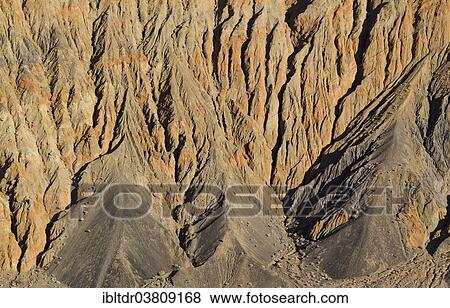 "Exposed fissured bedrock of orange-colored conglomerate on the crater wall of Ubehebe Crater, Death Valley, Death Valley National Park, California, USA" View Large Photo Image Stock Photo - "Exposed fissured bedrock of orange-colored conglomerate on the crater wall of Ubehebe Crater, Death Valley, Death Valley National Park, California, USA". Fotosearch