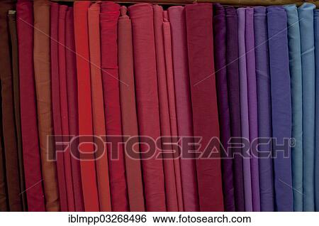 Stock Photograph - "Fabrics lined up on a rack, Varkala, Kerala, India, Asia". Fotosearch