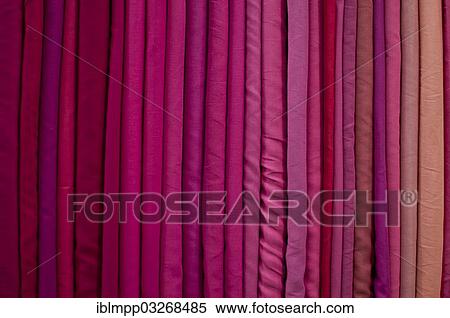 Stock Photography - "Fabrics lined up on a rack, Varkala, Kerala, India, Asia". Fotosearch