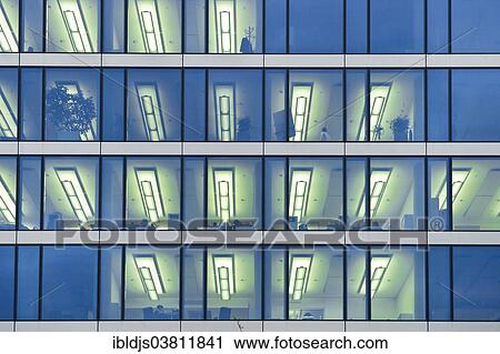 "Facade of a modern office building with lights on in the offices in the evening, Munich, Bavaria, Germany, Europe" View Large Photo Image Stock Image - "Facade of a modern office building with lights on in the offices in the evening, Munich, Bavaria, Germany, Europe". Fotosearch