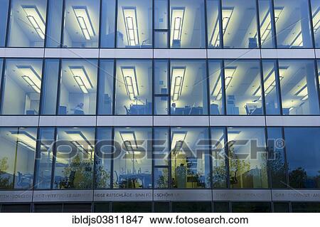 "Facade of a modern office building with lights on in the offices in the evening, Munich, Bavaria, Germany, Europe" View Large Photo Image Stock Photo - "Facade of a modern office building with lights on in the offices in the evening, Munich, Bavaria, Germany, Europe". Fotosearch