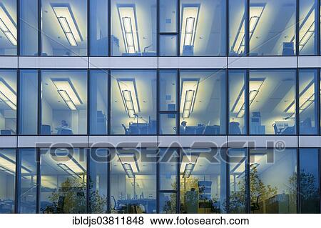 "Facade of a modern office building with lights on in the offices in the evening, Munich, Bavaria, Germany, Europe" View Large Photo Image Stock Photo - "Facade of a modern office building with lights on in the offices in the evening, Munich, Bavaria, Germany, Europe". Fotosearch