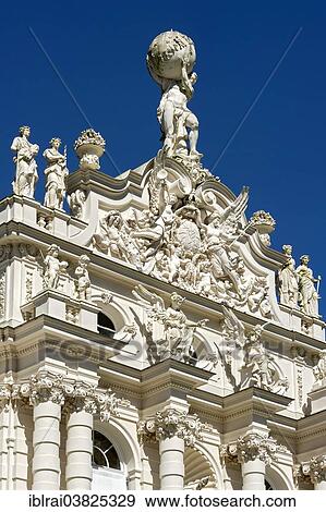 Stock Photo - "Facade of Schloss Linderhof Palace with figures of angels, putti and a statue of Atlas supporting the celestial sphere on the roof, Upper Bavaria, Bavaria, Germany, Europe". Fotosearch