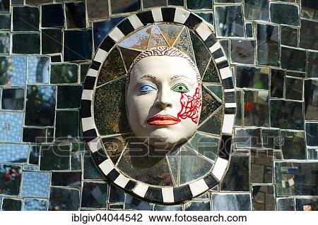 Stock Image - "Face in relief in the Giardino dei Tarocchi or Garden of the Tarot, by Niki de Saint Phalle and Jean Tinguely in Capalbio, Province of Grosseto, Tuscany, Italy, Europe". Fotosearch