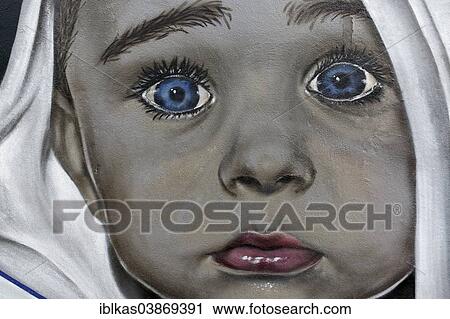 Stock Image - "Face of a baby looking scared, mural, Dusseldorf, North Rhine-Westphalia, Germany, Europe". Fotosearch