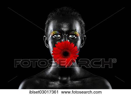 "Face of a young woman painted with black facepaint, with multi-coloured eyelashes and a flower in her mouth, Austria, Europe" View Large Photo Image Stock Image - "Face of a young woman painted with black facepaint, with multi-coloured eyelashes and a flower in her mouth, Austria, Europe". Fotosearch