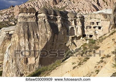 "Fairy Chimneys and cliff dwellings made of tufa, Goreme National Park, near Cavusin, Cappadocia, Nevsehir Province, Central Anatolia Region, Turkey, Asia" View Large Photo Image Stock Photo - "Fairy Chimneys and cliff dwellings made of tufa, Goreme National Park, near Cavusin, Cappadocia, Nevsehir Province, Central Anatolia Region, Turkey, Asia". Fotosearch