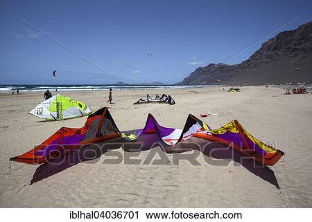 Stock Image - "Famara beach, Playa de Famara, kite sail in front, in the back Risco de Famara and Graciosa Island, Lanzarote, Canary Islands, Spain, Europe". Fotosearch