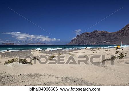 "Famara beach, Playa de Famara, right Risco de Famara, rear left Graciosa Island, Lanzarote, Canary Islands, Spain, Europe" View Large Photo Image Stock Photograph - "Famara beach, Playa de Famara, right Risco de Famara, rear left Graciosa Island, Lanzarote, Canary Islands, Spain, Europe". Fotosearch