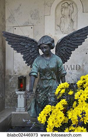 "Family grave with angel, votive candle and flowers on the Ostfriedhof or East Cemetery, Munich, Bavaria, Germany, Europe" View Large Photo Image Stock Image - "Family grave with angel, votive candle and flowers on the Ostfriedhof or East Cemetery, Munich, Bavaria, Germany, Europe". Fotosearch