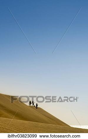 "Family hiking in the dunes of Maspalomas, Gran Canaria, Canary Islands, Spain, Europe" View Large Photo Image Stock Photo - "Family hiking in the dunes of Maspalomas, Gran Canaria, Canary Islands, Spain, Europe". Fotosearch