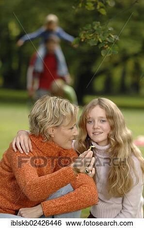 "Family in the park, mother and daughter in the foreground" View Large Photo Image Stock Photograph - "Family in the park, mother and daughter in the foreground". Fotosearch