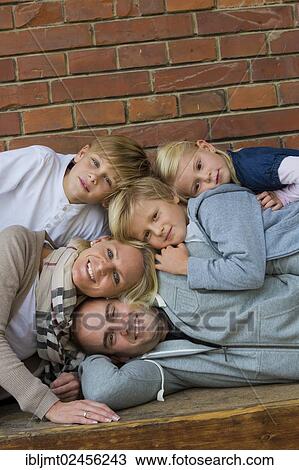 Stock Image - "Family portrait with three children, stacked". Fotosearch