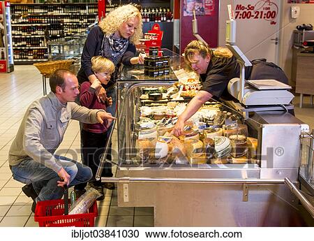 Stock Image - "Family shopping at the cheese counter in the supermarket, Germany, Europe". Fotosearch