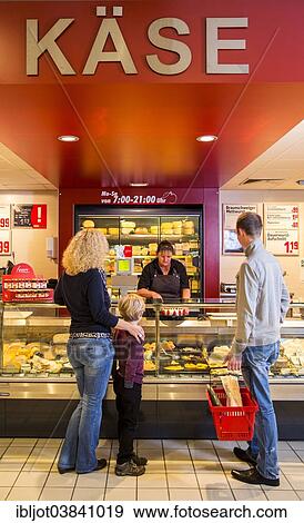 "Family shopping at the cheese counter in the supermarket, Germany, Europe" View Large Photo Image Stock Photo - "Family shopping at the cheese counter in the supermarket, Germany, Europe". Fotosearch