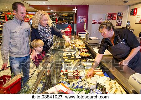 "Family shopping at the cheese counter in the supermarket, Germany, Europe" View Large Photo Image Stock Photo - "Family shopping at the cheese counter in the supermarket, Germany, Europe". Fotosearch