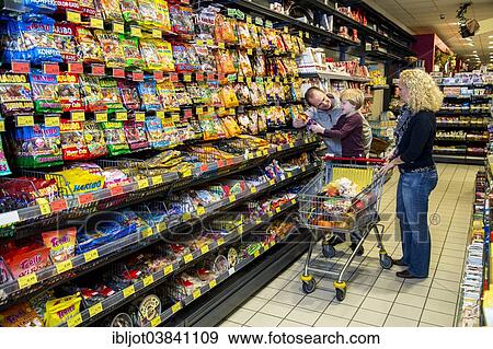 "Family shopping in the candy section of a supermarket, Germany, Europe" View Large Photo Image Stock Photo - "Family shopping in the candy section of a supermarket, Germany, Europe". Fotosearch