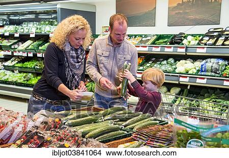 "Family shopping with a shopping trolley in the fruit and vegetables department of a supermarket, Germany, Europe" View Large Photo Image Picture - "Family shopping with a shopping trolley in the fruit and vegetables department of a supermarket, Germany, Europe". Fotosearch