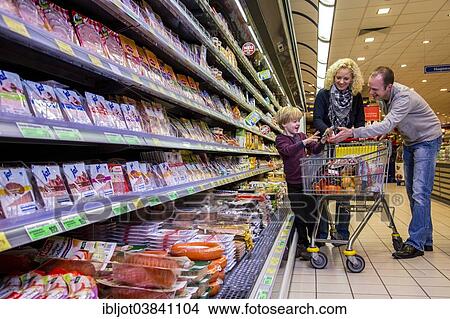 "Family shopping with a shopping trolley in the refrigerated section of a supermarket with packed meat, Germany, Europe" View Large Photo Image Picture - "Family shopping with a shopping trolley in the refrigerated section of a supermarket with packed meat, Germany, Europe". Fotosearch