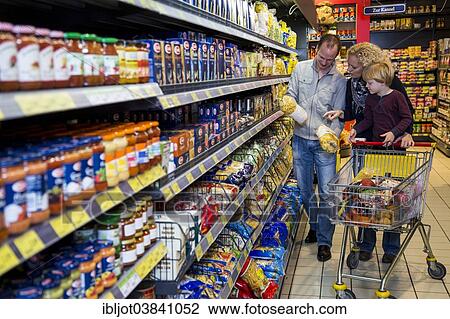 "Family shopping with a shopping trolley in a supermarket, aisle with various foodstuffs, Germany, Europe" View Large Photo Image Stock Image - "Family shopping with a shopping trolley in a supermarket, aisle with various foodstuffs, Germany, Europe". Fotosearch