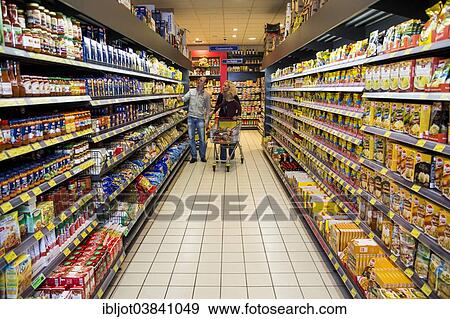 "Family shopping with a shopping trolley in a supermarket, aisle with various foodstuffs, Germany, Europe" View Large Photo Image Stock Photo - "Family shopping with a shopping trolley in a supermarket, aisle with various foodstuffs, Germany, Europe". Fotosearch