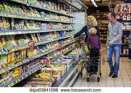 "Family shopping with a shopping trolley in the refrigerated section of a supermarket, Germany, Europe" View Large Photo Image Stock Photo - "Family shopping with a shopping trolley in the refrigerated section of a supermarket, Germany, Europe". Fotosearch