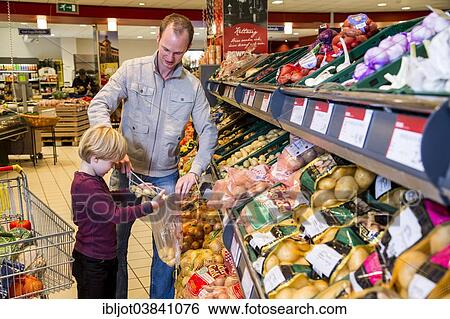 "Family shopping with a shopping trolley in the fruit and vegetables department of a supermarket, Germany, Europe" View Large Photo Image Stock Photograph - "Family shopping with a shopping trolley in the fruit and vegetables department of a supermarket, Germany, Europe". Fotosearch