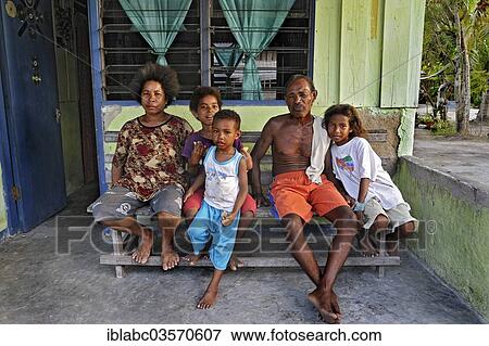 "Family sitting on a bench, Arborek, Raja Ampat, West Papua, Indonesia, Asia" View Large Photo Image Stock Photo - "Family sitting on a bench, Arborek, Raja Ampat, West Papua, Indonesia, Asia". Fotosearch