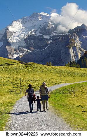 Stock Photograph - "Family walking, Grindelwald First, Swiss Alps, Switzerland, Europe". Fotosearch