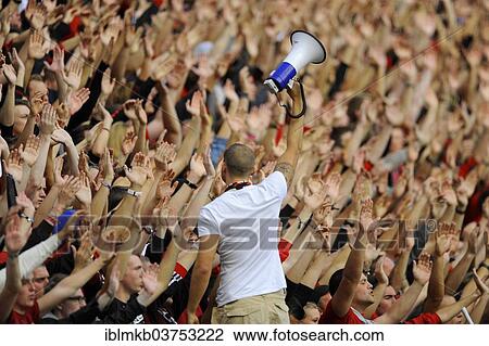 "Fans of football club Bayer 04 Leverkusen cheering on their team, leader holding a megaphone at front, Leverkusen, North Rhine-Westphalia, Germany, Europe" View Large Photo Image Stock Image - "Fans of football club Bayer 04 Leverkusen cheering on their team, leader holding a megaphone at front, Leverkusen, North Rhine-Westphalia, Germany, Europe". Fotosearch