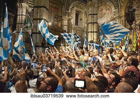 "Fans waving flags, Contrada Capitana of the Wave or Capitana Contrada dell'Onda, Palio di Siena, Siena Cathedral, Cattedrale di Santa Maria Assunta, Siena, Tuscany, Italy, Europe" View Large Photo Image Stock Photo - "Fans waving flags, Contrada Capitana of the Wave or Capitana Contrada dell'Onda, Palio di Siena, Siena Cathedral, Cattedrale di Santa Maria Assunta, Siena, Tuscany, Italy, Europe". Fotosearch