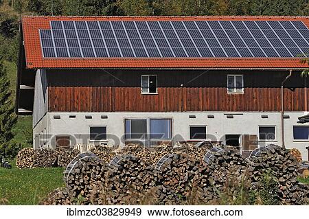 "Farm with photovoltaic panels, stacked firewood at the front, Reuterhof farm near Buhl am Alpsee, Oberallgau, Bavaria, Germany, Europe" View Large Photo Image Stock Photo - "Farm with photovoltaic panels, stacked firewood at the front, Reuterhof farm near Buhl am Alpsee, Oberallgau, Bavaria, Germany, Europe". Fotosearch