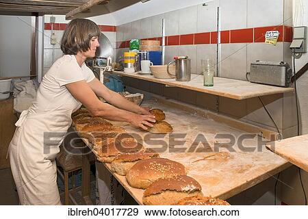 Stock Photo - "Farmer making bread in her own bakery on the farm, finished breads, Tyrol, Austria, Europe". Fotosearch
