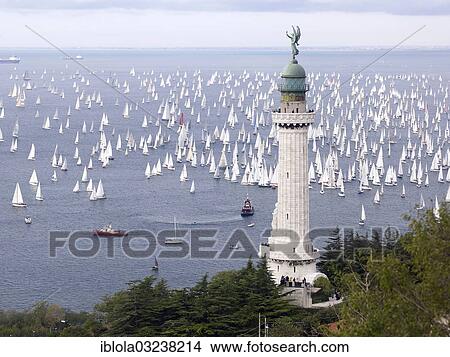 "Faro della Vittoria lighthouse, sailing boats taking part in the historic sailing regatta Barcolana at back, Trieste, Province of Trieste, Friuli-Venezia Giulia, Italy, Europe" View Large Photo Image Picture - "Faro della Vittoria lighthouse, sailing boats taking part in the historic sailing regatta Barcolana at back, Trieste, Province of Trieste, Friuli-Venezia Giulia, Italy, Europe". Fotosearch
