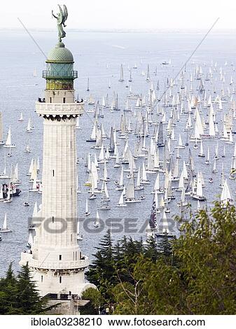 "Faro della Vittoria lighthouse, sailing boats taking part in the historic sailing regatta Barcolana at back, Trieste, Province of Trieste, Friuli-Venezia Giulia, Italy, Europe" View Large Photo Image Stock Image - "Faro della Vittoria lighthouse, sailing boats taking part in the historic sailing regatta Barcolana at back, Trieste, Province of Trieste, Friuli-Venezia Giulia, Italy, Europe". Fotosearch
