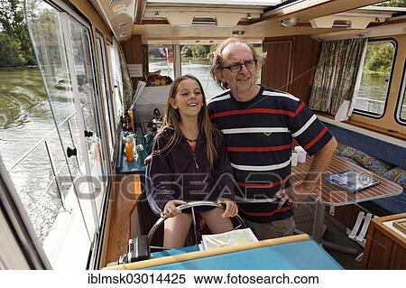 "Father and daughter at the wheel of a Penichette, a houseboat on the Saone River, Port-sur-Saone, Vesoul, Region Franche-Comte, Dep. Haute-Saone, France, Europe" View Large Photo Image Stock Photography - "Father and daughter at the wheel of a Penichette, a houseboat on the Saone River, Port-sur-Saone, Vesoul, Region Franche-Comte, Dep. Haute-Saone, France, Europe". Fotosearch