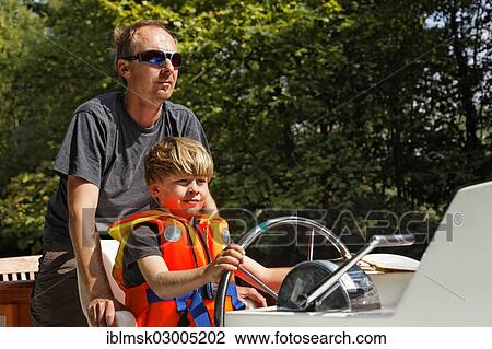 "Father and son at the helm of a houseboat on the Canal du Midi near Bram, Bram - Aude, Region Languedoc-Roussillon, France, Europe" View Large Photo Image Stock Image - "Father and son at the helm of a houseboat on the Canal du Midi near Bram, Bram - Aude, Region Languedoc-Roussillon, France, Europe". Fotosearch