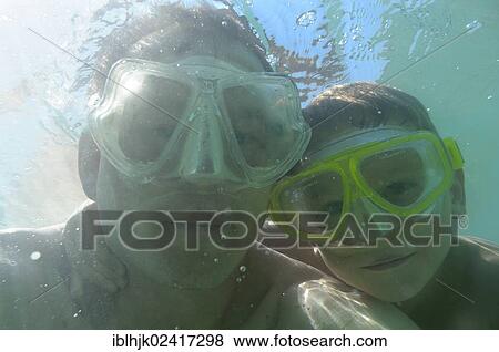 Father and son wearing diving goggles underwater, Vassiliki, Lefkas or Lefkada, Greece, Europe View Large Photo Image Stock Photo - Father and son wearing diving goggles underwater, Vassiliki, Lefkas or Lefkada, Greece, Europe. Fotosearch