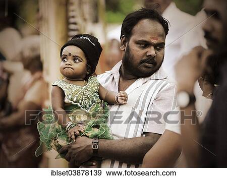 "Father holding a child at a temple festival, Kerala, South India, India, Asia" View Large Photo Image Stock Photo - "Father holding a child at a temple festival, Kerala, South India, India, Asia". Fotosearch
