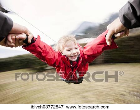 "Father letting his son """"fly""""" View Large Photo Image Stock Photo - "Father letting his son """"fly""""". Fotosearch