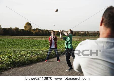 Father playing baseball with his sons View Large Photo Image Stock Image - Father playing baseball with his sons. Fotosearch