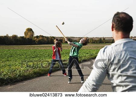 Father playing baseball with his sons View Large Photo Image Stock Image - Father playing baseball with his sons. Fotosearch
