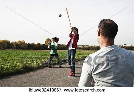 Father playing baseball with his sons View Large Photo Image Stock Photo - Father playing baseball with his sons. Fotosearch