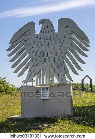 Stock Image - "Federal Eagle, 1999, artist Herbert Fell, installation in the Skulpturenpark Deutsche Einheit sculpture park of German Unity, Friedensweg peace path, Henneberg, Thuringia, Germany, Europe". Fotosearch