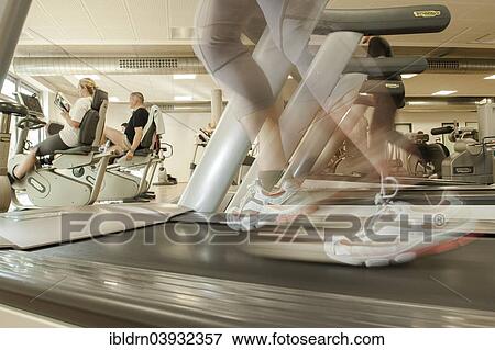 "Female athlete exercising on a treadmill in a gym, Oberhausen, North Rhine-Westphalia, Germany, Europe" View Large Photo Image Stock Photo - "Female athlete exercising on a treadmill in a gym, Oberhausen, North Rhine-Westphalia, Germany, Europe". Fotosearch