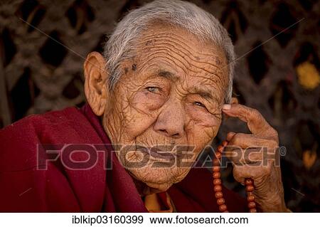 Stock Photo - "Female Buddhist monk, Boudhanath, Kathmandu, Kathmandu District, Bagmati Zone, Nepal, Asia". Fotosearch